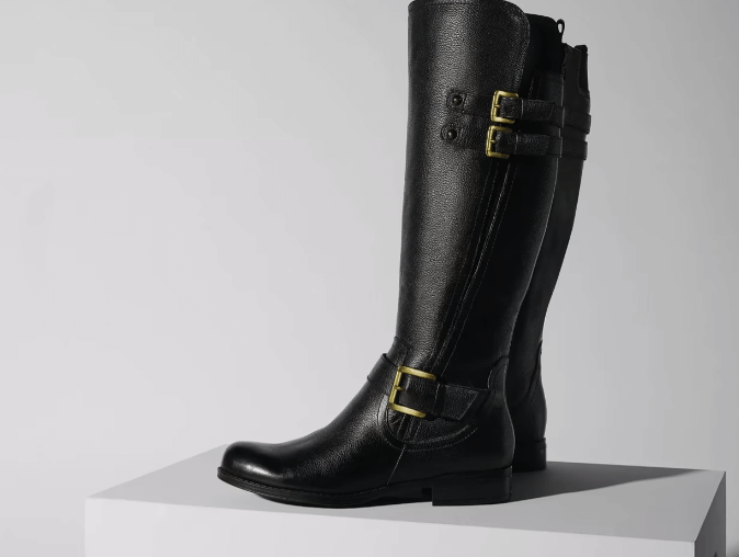 Black leather knee-high boots on display